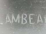 a close up of a silver vase with a name etched on it