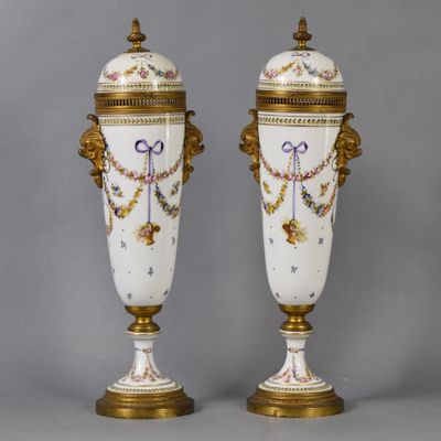 pair of antique porcelain vases with gold trimmings and handles