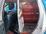 a blue van with a door open and stairs in the back