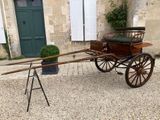 a horse drawn carriage parked in front of a building