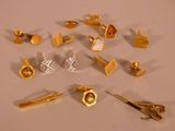 many different types of gold jewelry on a table