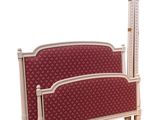 a white bed with a red upholstered headboard and foot board