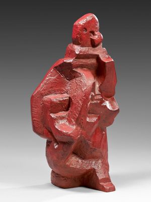 a red sculpture of a man with a hat on his head