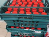 many plastic containers with red lids stacked on top of each other