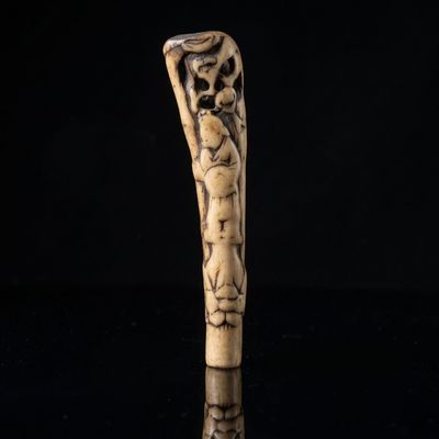 an old carved cane with a skeleton head on it