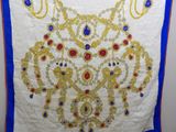 a close up of a white and blue cloth with a gold and blue design on it