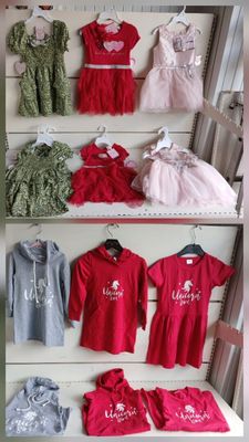 many different types of baby clothes on display in a store