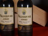 two bottles of wine sitting next to each other on a table