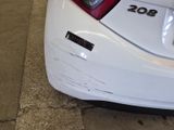 a white car with a number plate on the back of it