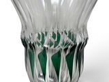 a glass vase that is sitting on a white surface
