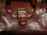 leather handbag with a brown leather handle and a brown leather strap