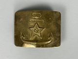 an old brass belt buckle with a star and anchor on it
