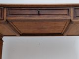 a small wooden table with two drawers on it