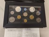 an image of a box of coins sitting on top of a table next to a sheet of paper