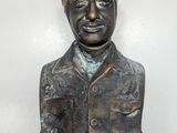 bronze bust of a man with goggles on his head