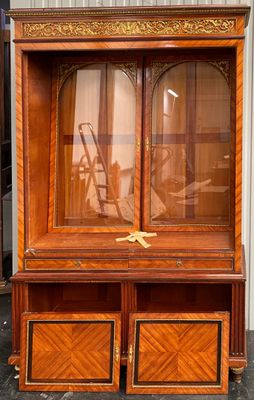 a large wooden cabinet with a glass door on it