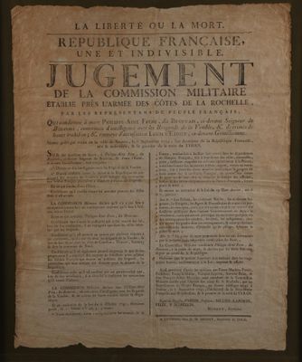 un vieux papier bordé d'une bordure noire, avec à côté la photo d'un homme debout