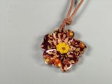 brown and yellow flower pendant on a brown cord