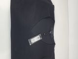 the back of a black t - shirt with a label on it