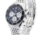 the watch is on a silver bracelet with a black face