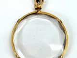 un pendentif plaqué or renfermant un verre transparent