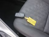 a yellow tag on the seat of a car with a key in it