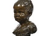 bronze bust of a boy with a collared shirt on a pedestal
