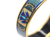 a close up of a ring with blue and yellow designs on it