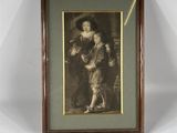 an old picture of a woman holding a dog in a wooden frame