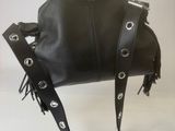 someone is holding a black purse with a chain around it