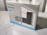 boxed box of a smart lock on a table in front of a window