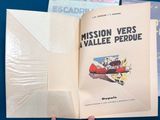 a person holding an open book with a picture of a plane on it
