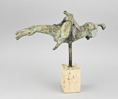 sculpture of a man on a horse on a block