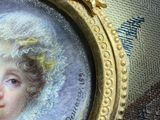 a picture of a portrait of a woman in a gold frame