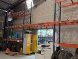 a large warehouse with a lot of pallets and a lot of wires