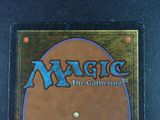 a close up of a magic the gathering card on a black surface