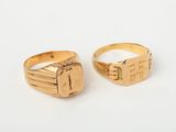 a pair of gold rings on a white background