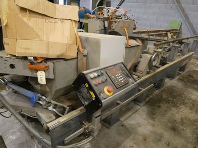 a machine that is sitting in a warehouse with boxes on it