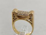 a close up of a gold ring with diamonds on it