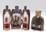 two figurines of a man and a woman in front of a church