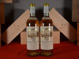 two bottles of wine sitting next to each other on a table