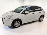 a picture of a white car parked in a garage