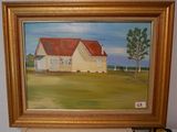 un tableau représentant une maison, posé sur une étagère dans une pièce