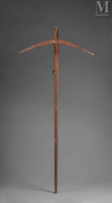 a tall wooden pole with a wooden handle on a gray background