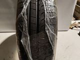 a close up of a car tire wrapped in plastic on a table