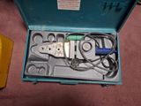a blue box with tools inside of it on the floor