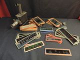 a pile of old photos and a camera on a table