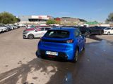 a blue car that is parked in a parking lot