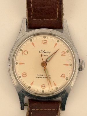 a close up of a wrist watch with a brown leather strap