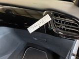 the dashboard of a car with a sticker attached to it ' s dashboard